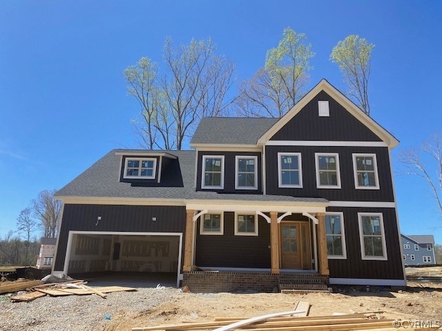 View of front of house with a porch and a garage