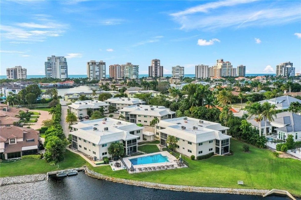 View of urban area featuring a large body of water and a pool area