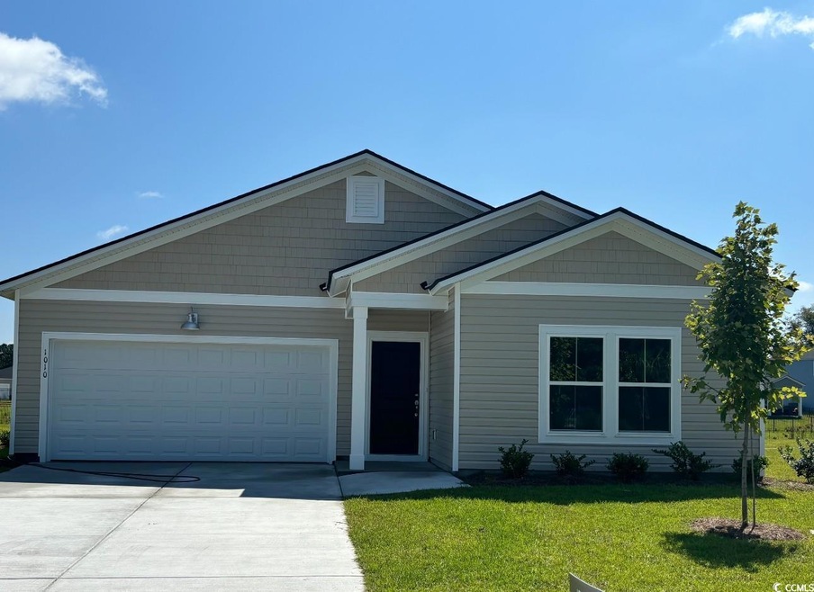View of front of home with a garage and a front la