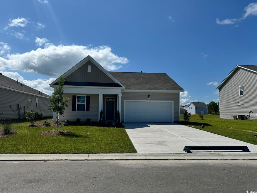 View of front facade with a garage and a front yar