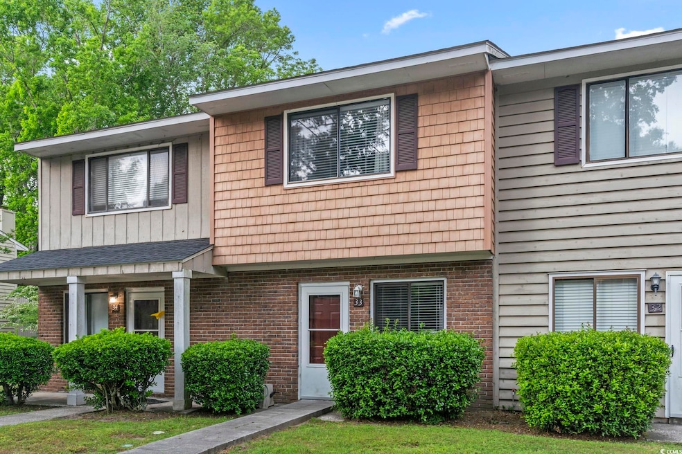 Townhome / multi-family property with brick siding