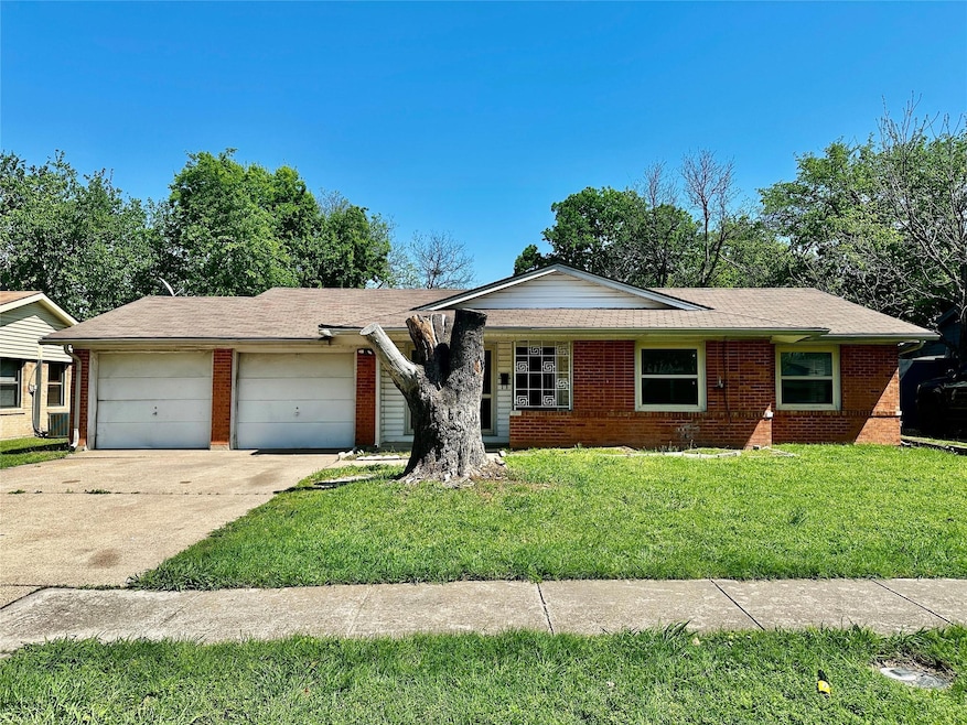 Ranch-style home with an attached garage, driveway