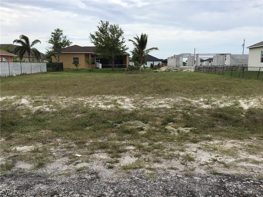 View looking straight on the lot, new homes being built all around