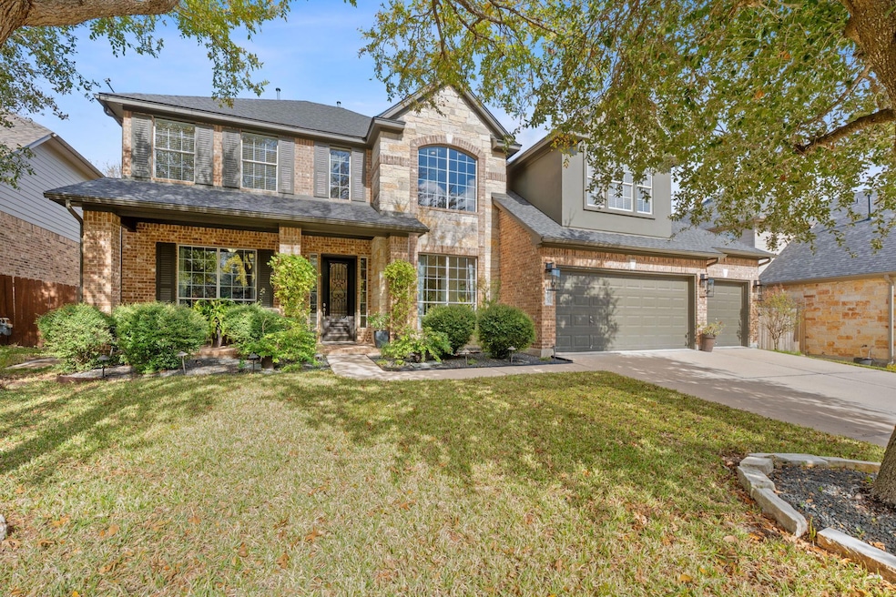 Traditional-style home with driveway, a porch, brick siding, and a garage