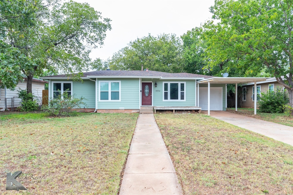 Ranch-style house with a front lawn and driveway