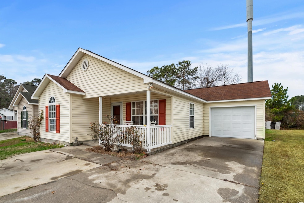 Single story home with a garage and covered porch