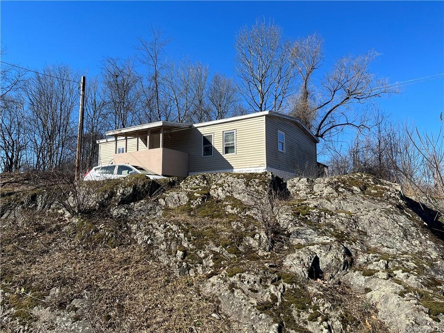 Front of home. Sits on a cool rock ledge