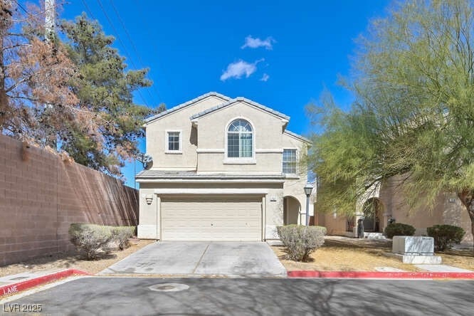 Traditional home with a garage, concrete driveway,