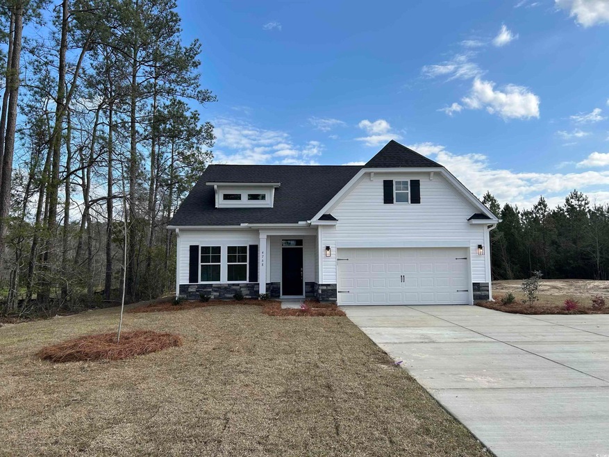 View of front facade featuring driveway, an attach