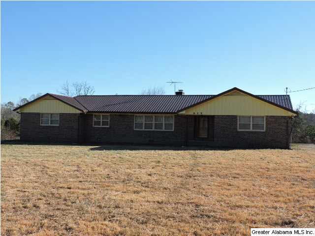 Front of home with large yard.
