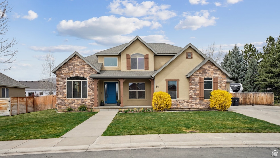 Craftsman-style house featuring stone siding, fence, a front yard, and stucco siding