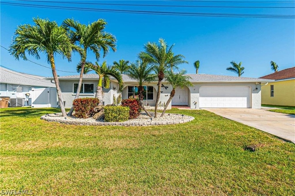 Single story home with a garage and a front yard