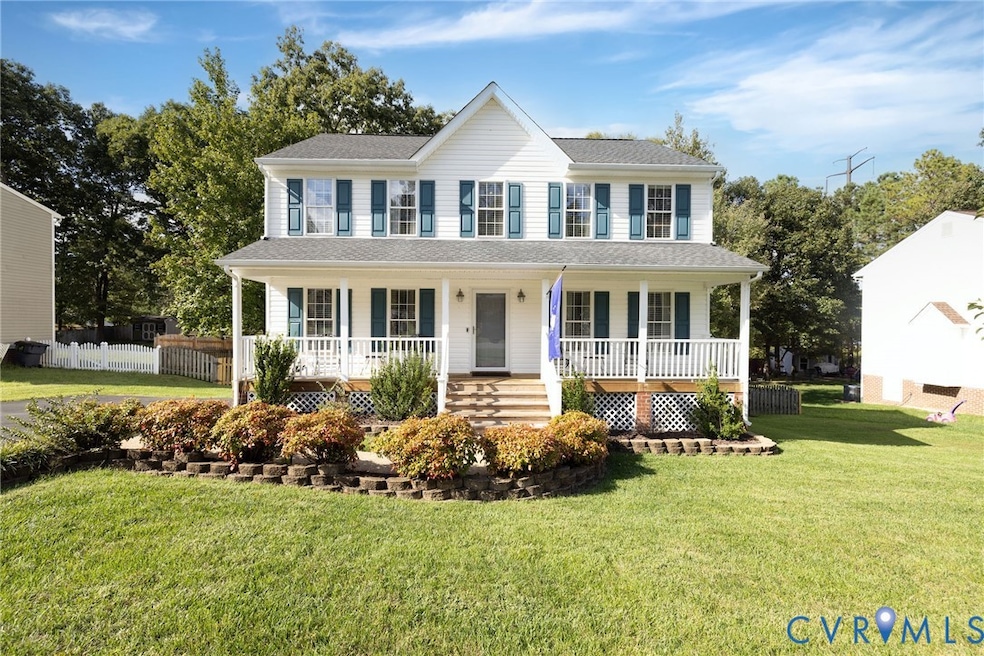 Colonial home featuring a porch and roof with shingles