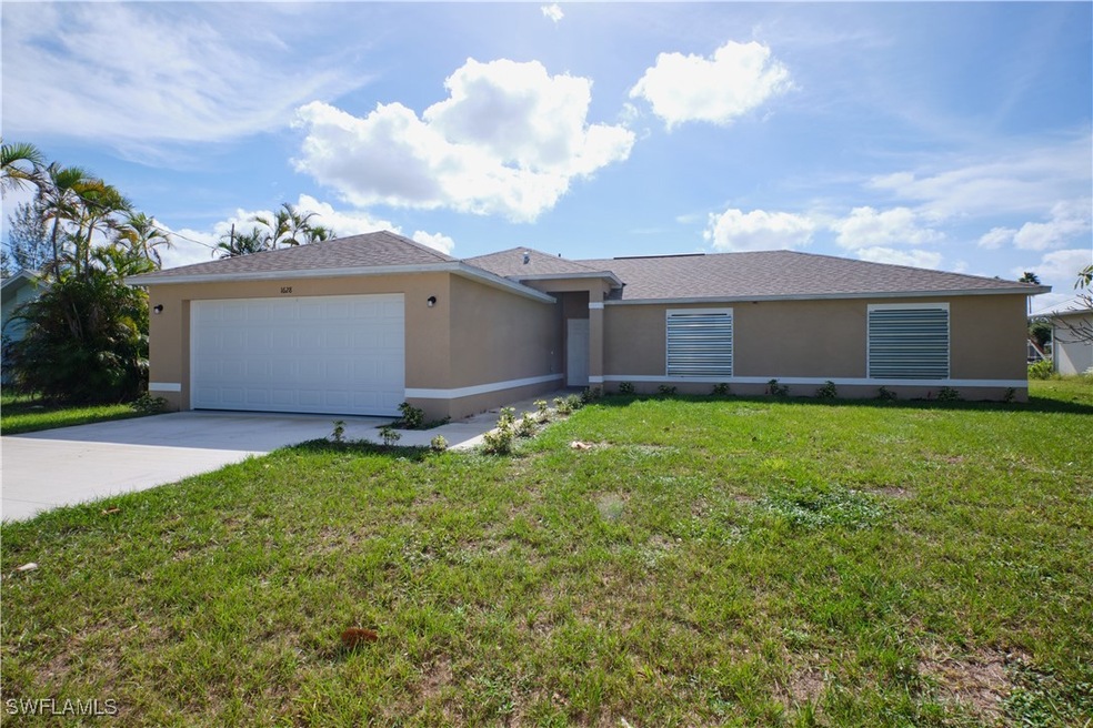Ranch-style home featuring a front lawn and a gara