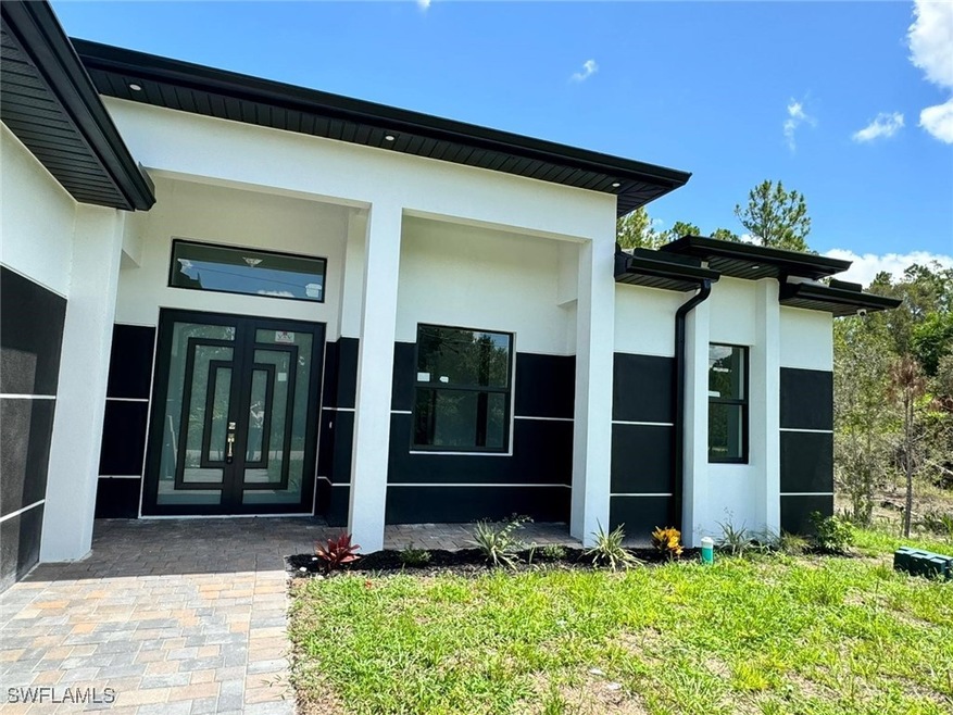 Doorway to property featuring stucco siding