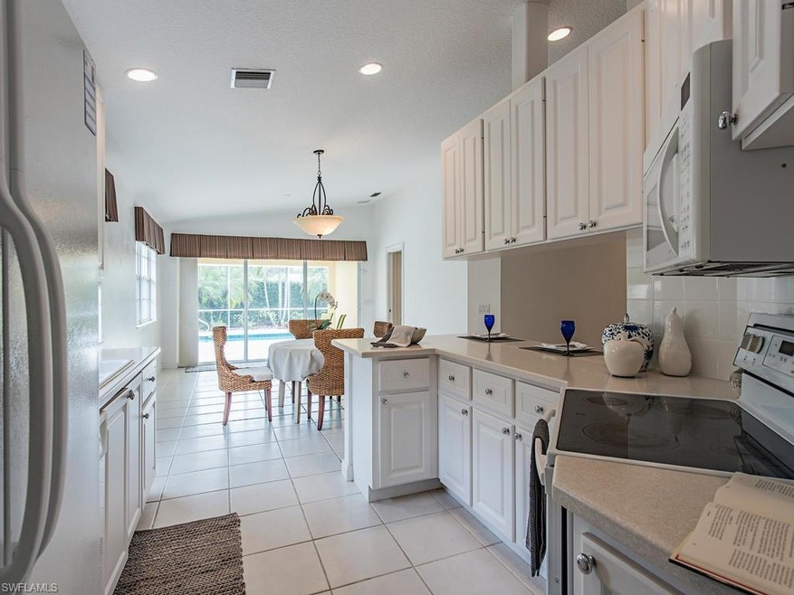 White cabinetry, corian countertops - this home is