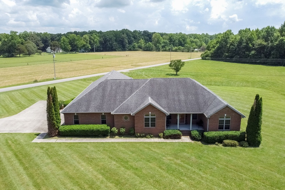 This custom  home is located on 5.38 acres of beautiful level land. It could be a family compound with the possibility of additional building sites.