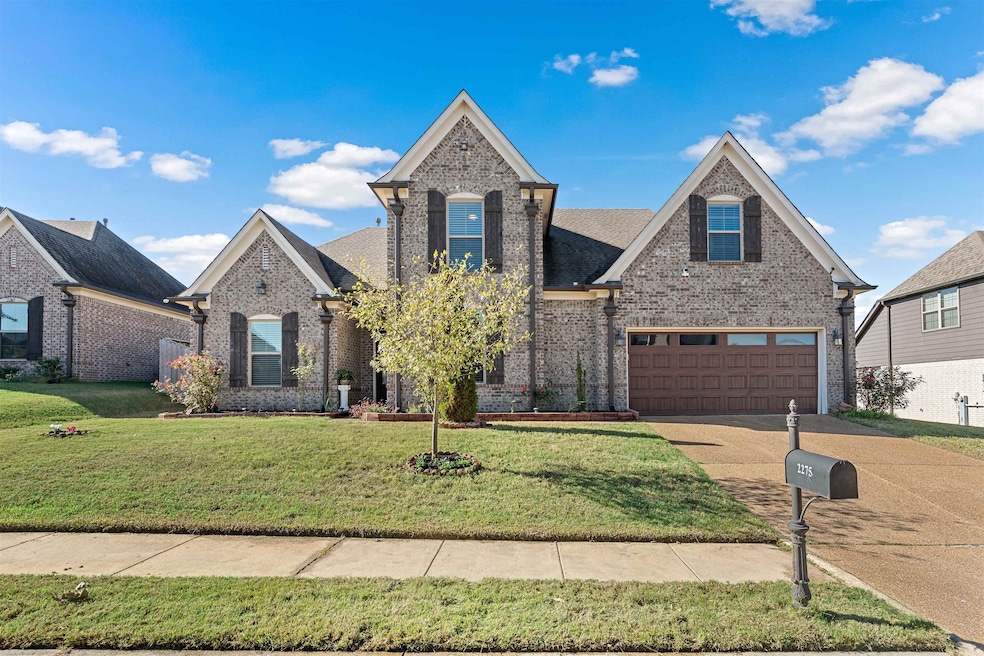 View of front of home with a garage and a front la