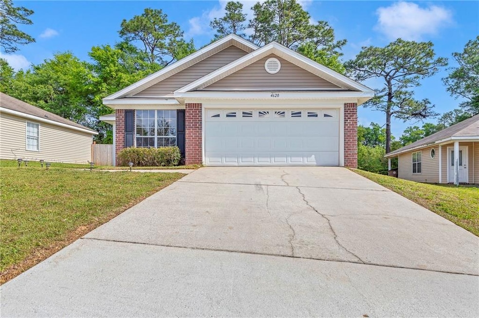 Single story home with a front lawn, brick siding,