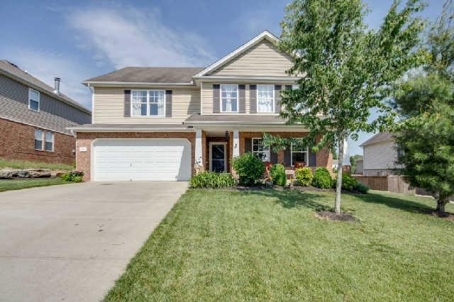A finely trimed yard will welcome you guests coming over to visit.