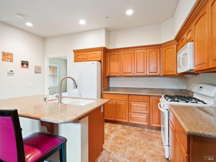 Kitchen View showing island with sink. The doorway is to the primary bedroom.