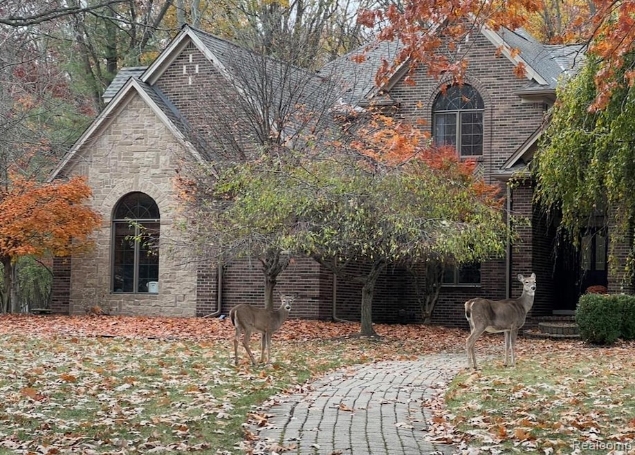 View of side of property with stone siding and brick siding