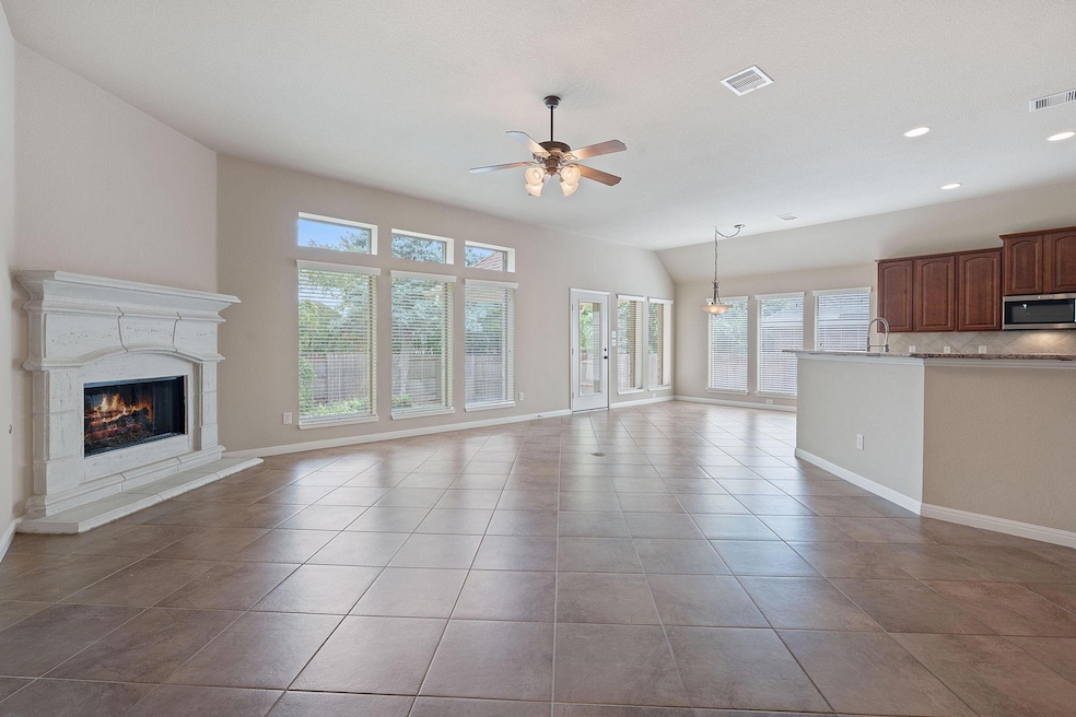 Unfurnished living room featuring a ceiling fan, 