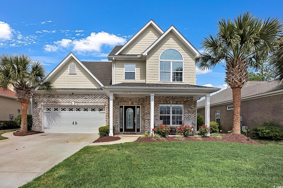 Traditional-style house with brick siding, drivewa