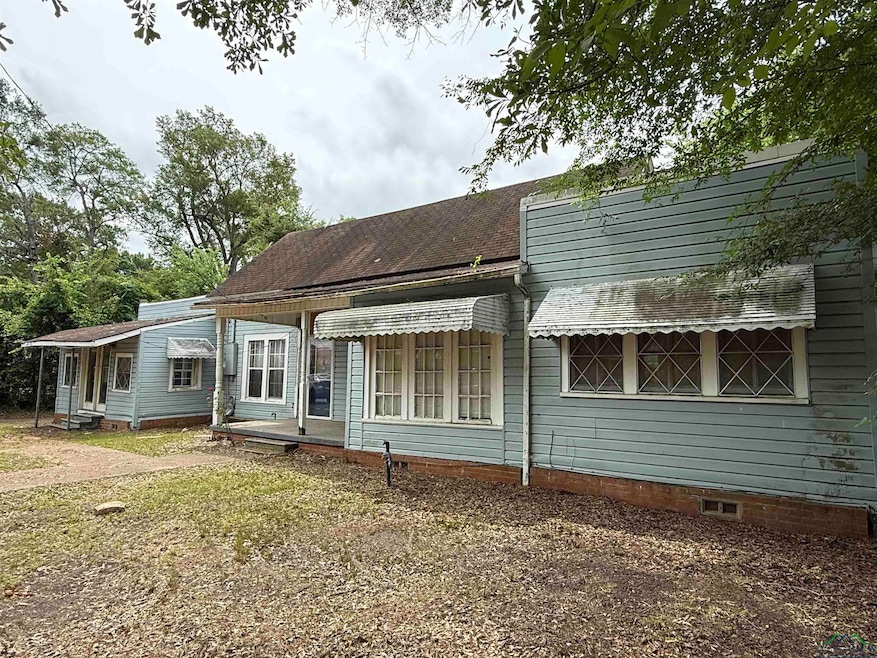 Back of house with a shingled roof