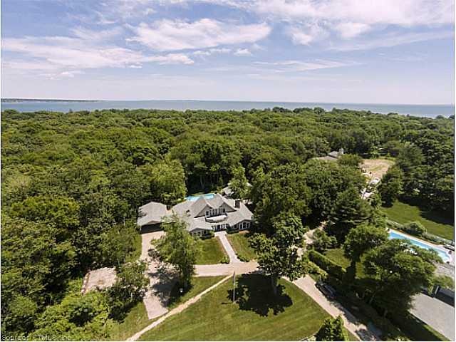 Exterior Front. Aerial front view w water in backg