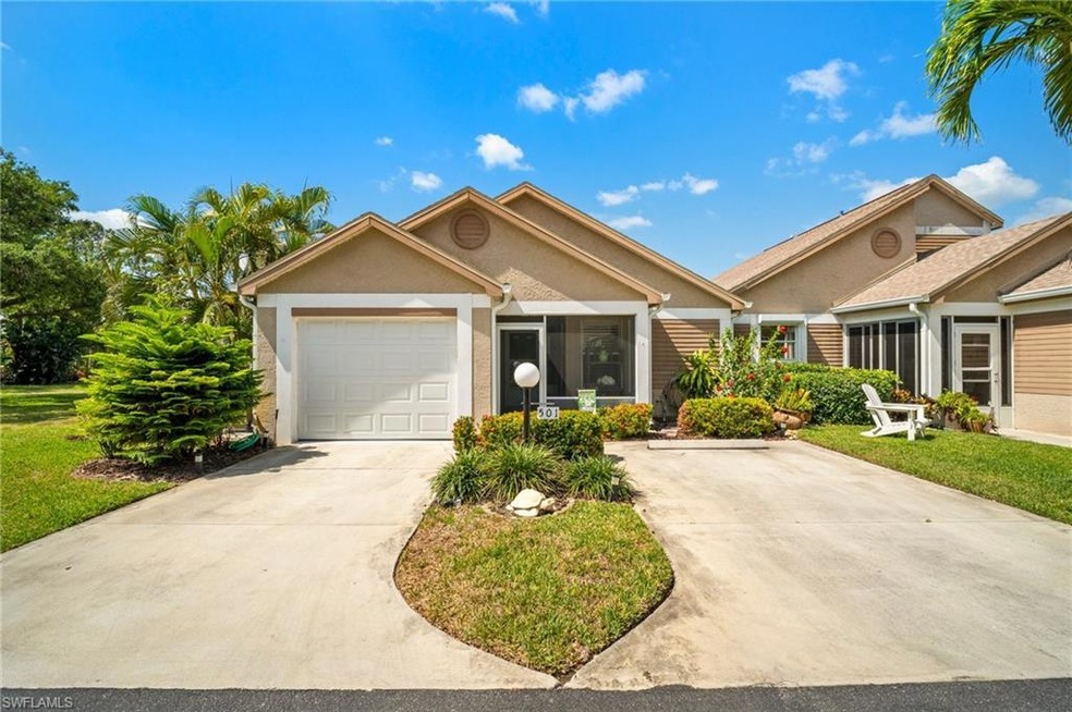 Ranch-style house with concrete driveway, a garage, stucco siding, and a front yard