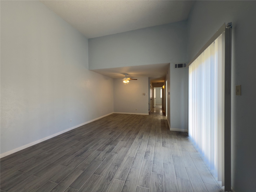 Large living room with high ceilings or doors that lead to the backyard