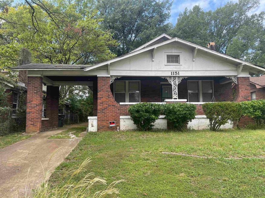 Bungalow-style house featuring a carport and a fro