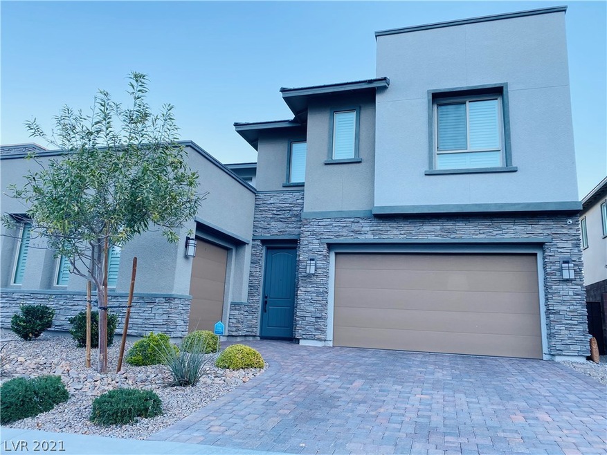 Contemporary front entrance with three car garage