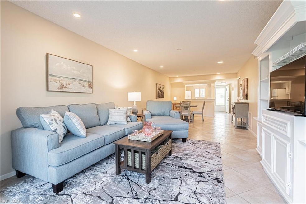 Living area with light tile patterned floors, rece