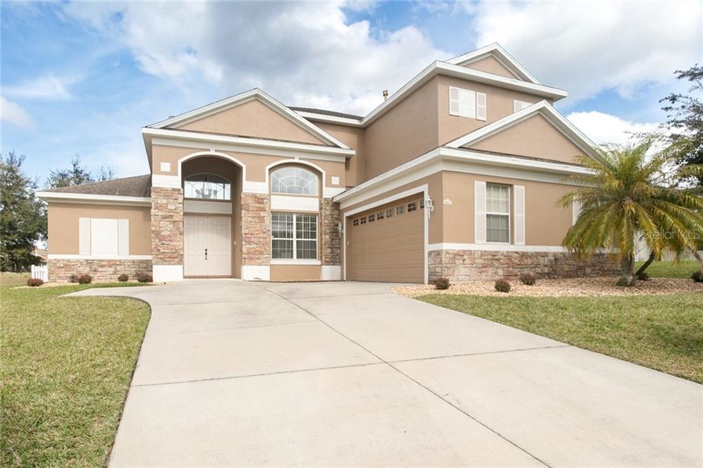 Beautiful home with stacked stone accents, neutral