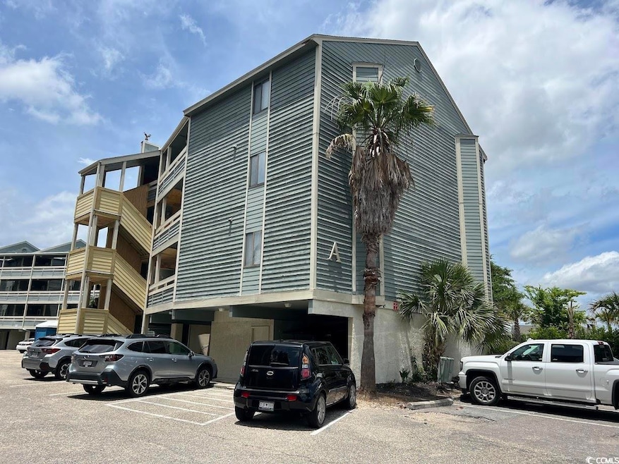 View of property featuring uncovered parking