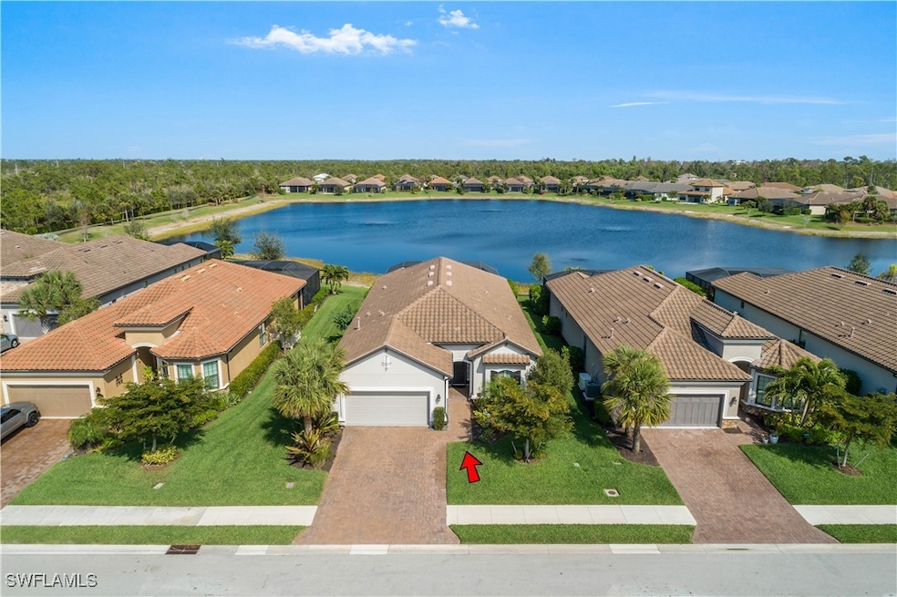 Birds eye view of property with a water view