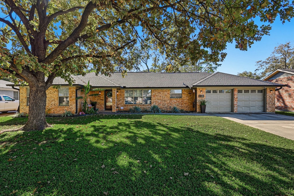 Ranch-style home with a front yard, brick siding, driveway, and a shingled roof