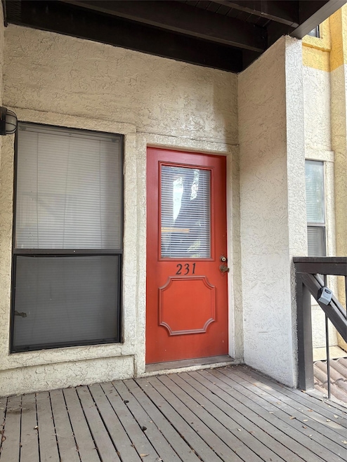 Entrance to property with stucco siding