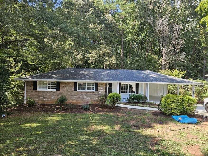 Ranch-style home featuring a front lawn