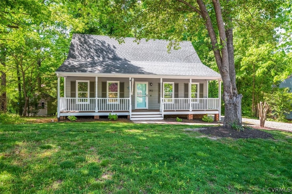 View of front of house with a front lawn and cover