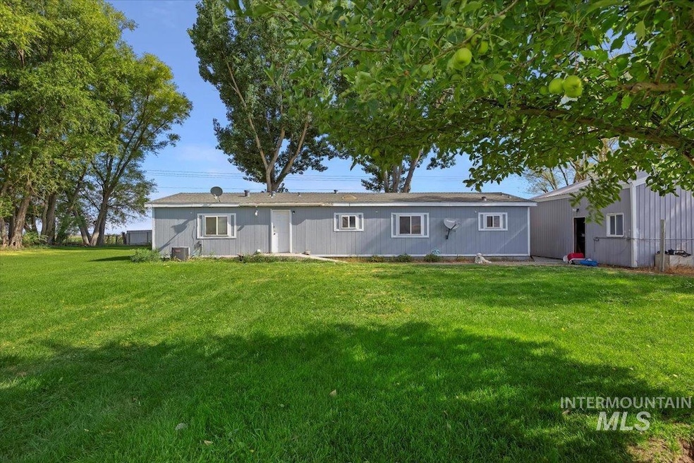 Rear view of property featuring a yard