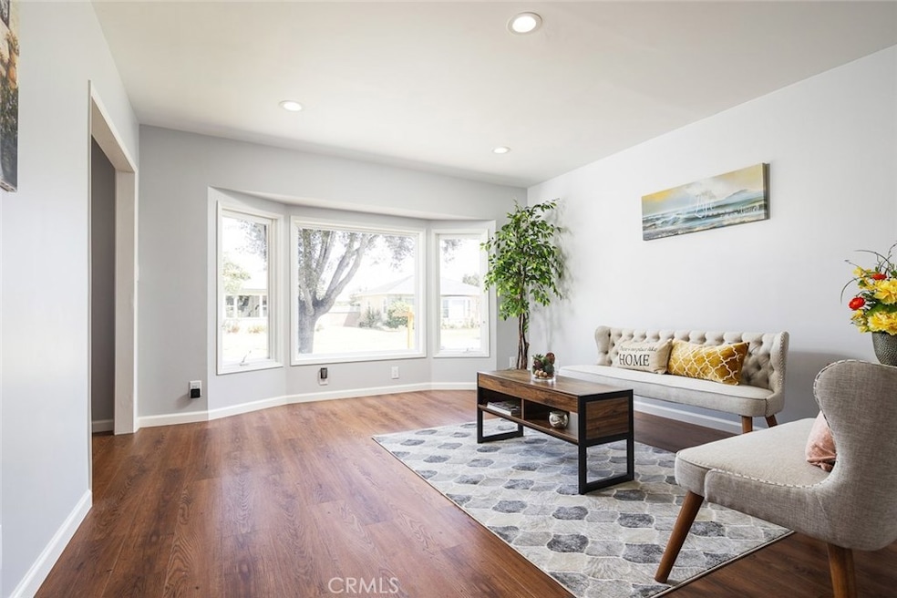 Gorgeous living room setting with glorious natural lights shining through the bay windows