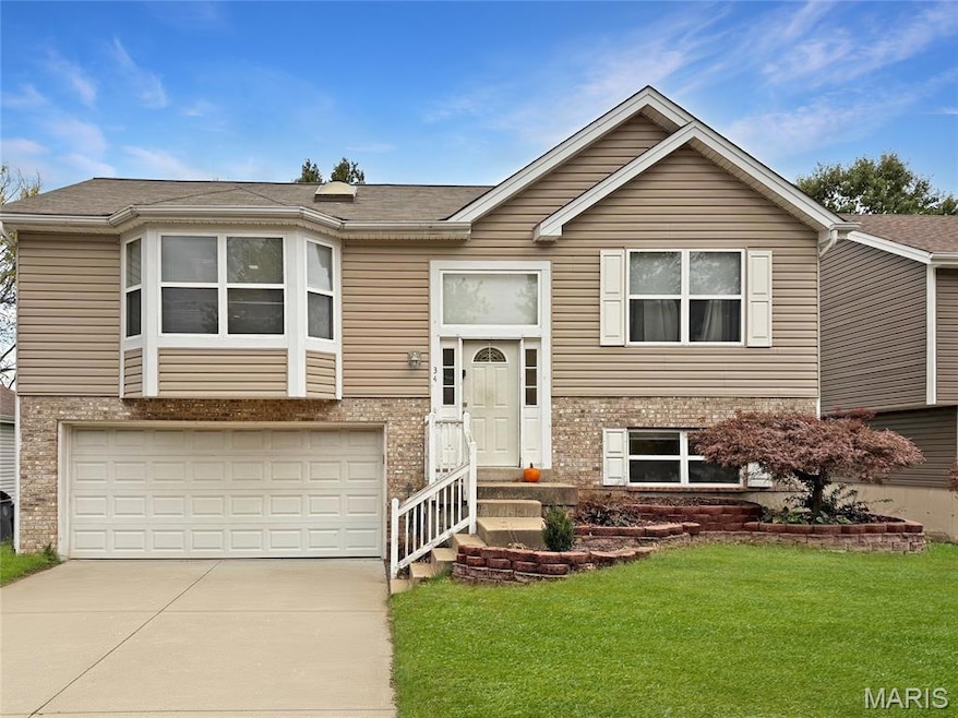 Bi-level home featuring brick siding, driveway, a front lawn, a garage, and roof with shingles