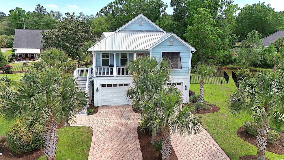 View of front of house featuring decorative drivew