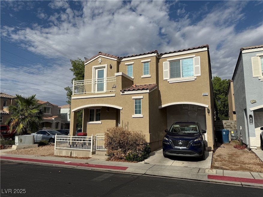 View of front of home with a balcony, a tile roof,