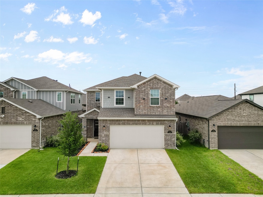 Modern two-story brick home with a double garage,