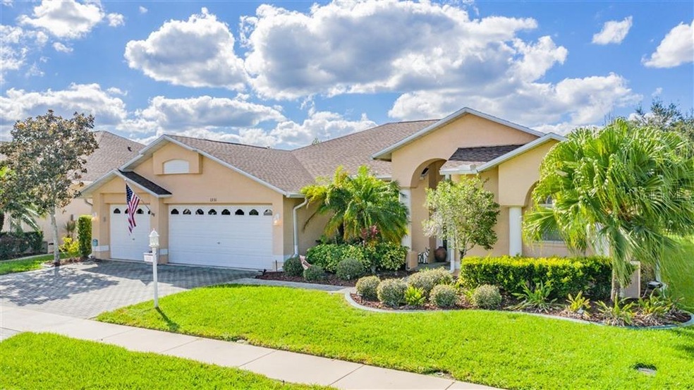 Beautiful landscaped curb appeal with a three car 