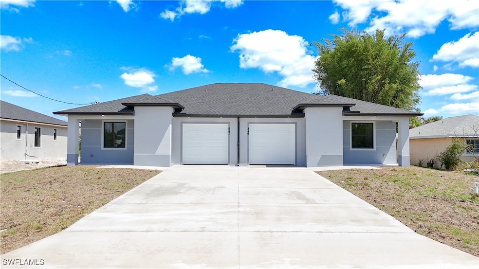 View of front of home with a garage, a shingled ro